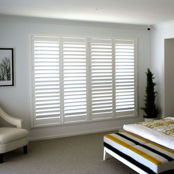 Bedroom with white plantation shutters